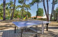 a ping pong table in a park with a playground at 2 Bedroom Beautiful Home In La Faute-sur-mer in La Faute-sur-Mer