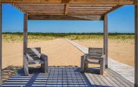 two chairs sitting on a boardwalk on the beach at 2 Bedroom Beautiful Home In La Faute-sur-mer in La Faute-sur-Mer