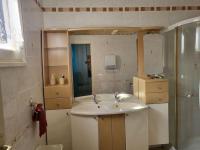 a bathroom with a sink and a shower at Rez de villa tout confort in Furiani