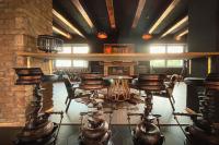 ブレズノにあるHOTEL DOUBLE RED CARS Museumの部屋の中に椅子とテーブルが置かれたバー