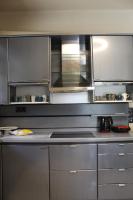 a kitchen with stainless steel cabinets and a stove at Villa Khaki 
