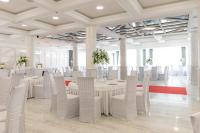 a large room with white tables and white chairs at Complex Turistic Darina Sancraiu de Mures in Sîncraiu de Mureş