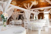 a wedding banquet hall with white tables and chairs at Complex Turistic Darina Sancraiu de Mures in Sîncraiu de Mureş