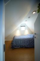 a bedroom with a bed in a attic at Apartment with a view and parking in Brecht