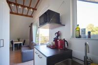 a kitchen with a sink and a counter top at Apartment with a view and parking in Brecht