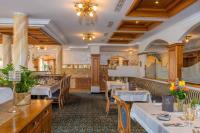 Un restaurante con mesas y sillas en una sala. en Kristall- & Vitalhotel Bergknappenhof, en Bodenmais