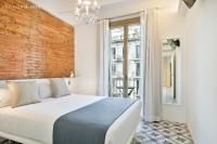 Postel nebo postele na pokoji v ubytování Uma Suites Sagrada Familia