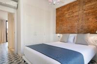 Postel nebo postele na pokoji v ubytování Uma Suites Sagrada Familia