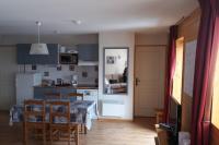 a kitchen and dining room with a table and chairs at CHAMROUSSE T2 Sud Ski Rando et Vtt aux pieds Les balcons du Recoin in Chamrousse