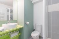 a bathroom with a white toilet and a sink at Appart’City Confort Tours in Tours