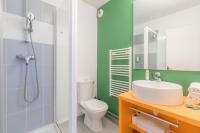 a bathroom with a shower and a toilet and a sink at Appart’City Confort Tours in Tours