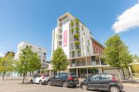 a group of cars parked in front of a building at Appart’City Confort Tours in Tours