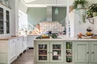 a kitchen with white cabinets and a counter with fruits at Beautiful loft in the 20th district of Paris - Welkeys in Paris