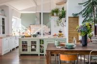 a kitchen with a wooden table and chairs at Beautiful loft in the 20th district of Paris - Welkeys in Paris