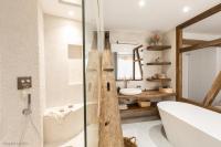 a bathroom with a shower and a tub and a sink at Beautiful loft in the 20th district of Paris - Welkeys in Paris