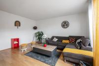 a living room with a couch and a table at Charming 2br a 2 steps from the Stade de France - Welkeys in Saint-Denis