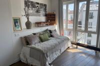 a living room with a couch and a large window at Beautiful loft in the 20th district of Paris - Welkeys in Paris