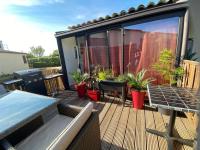 a deck with potted plants and a swimming pool at Charmante maison avec extérieur à deux pas des remparts in Aigues-Mortes