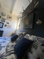 a bedroom with a bed with blue pillows on it at Charmante maison avec extérieur à deux pas des remparts in Aigues-Mortes