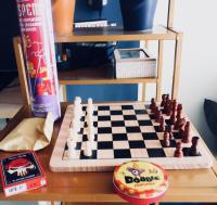 a wooden chess board with a chessboard and a board at Foyal City Center in Fort-de-France