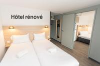 Dos camas en una habitación de hotel con un cartel de &quot;Quitar hotel&quot; en Hotel Inn Design La Rochelle, en La Rochelle