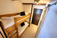two bunk beds in a small room with a door at Chamonixholidays in Chamonix