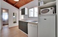 a kitchen with a refrigerator and a microwave at 2 Bedroom Beautiful Home In La Faute-sur-mer in La Faute-sur-Mer