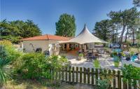a house with a white tent in a yard at 2 Bedroom Beautiful Home In La Faute-sur-mer in La Faute-sur-Mer