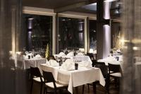 a restaurant with white tables and chairs with white table cloth at Break Sokos Hotel Koli in Kolinkylä