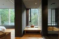 a bedroom with a wooden desk in a room with windows at Onsen Papawaqa in Tai&#39;an