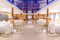 a large banquet hall with white tables and chairs at Sovinyon Resort in Odesa