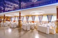 a large banquet hall with white tables and chairs at Sovinyon Resort in Odesa
