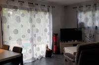 a living room with a couch and a large window at Villa contemporaine à 10mn des plages in Lattes