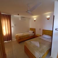 A bed or beds in a room at Nile Sunrise Flats