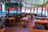 a dining room with wooden tables and chairs at Brand Business Hotel in Corlu