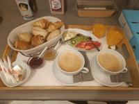 a tray with two cups of coffee and a tray of food at Chambre Lily in Parranquet