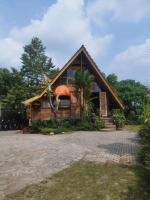 a house with a thatched roof and a porch at Kebun Hanoman Villa in Pablengan