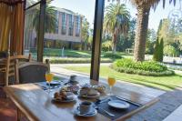 a wooden table with food and glasses of orange juice at Sheraton Pilar Hotel & Convention Center in Pilar