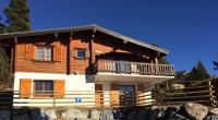 a wooden house with a balcony on a mountain at El Chalet du Père Castor in Bolquere Pyrenees 2000