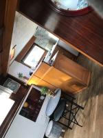 an overhead view of a kitchen with a stove and chairs at Péniche Match in Arles