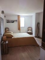 a bedroom with a large bed and a window at Magnifiques maisons de campagne au sein d&#39;un vignoble in Cazouls-lès-Béziers
