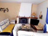 a living room with a couch and a fireplace at Magnifiques maisons de campagne au sein d&#39;un vignoble in Cazouls-lès-Béziers