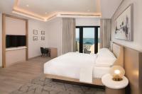 a hotel room with a bed and a view of the ocean at Sheraton Abu Dhabi Hotel & Resort in Abu Dhabi