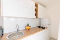 a kitchen with a sink and a bowl of fruit on a counter at NEW!!! Luminose beach house in Pakoštane