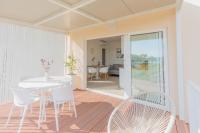 a dining room with a white table and chairs at NEW!!! Luminose beach house in Pakoštane