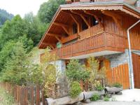a building with a balcony on top of it at Spacious holiday home near center of Champagny in Le Villard