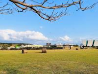 two hay bales sitting in a field in a field at Kenting Summerland Garden Resort in Eluan