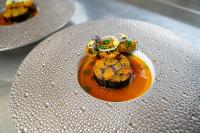 a plate with a dessert in a bowl on a table at Château De Noirieux in Briollay