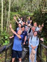 a group of people posing for a picture in the woods at Tianyi Homestay in Fenqihu