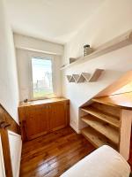 a room with a staircase with a window and wooden floors at Maison de pêcheur - À 200m de la plage in Ploemeur